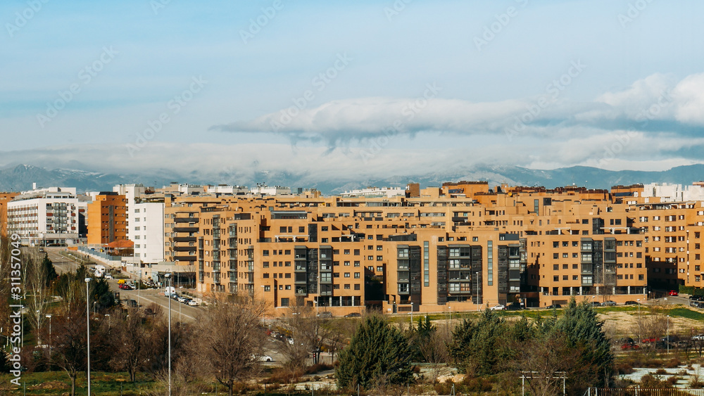 View of residential neighbourhood in Las Tablas, Madrid, Spain with mountain range in background