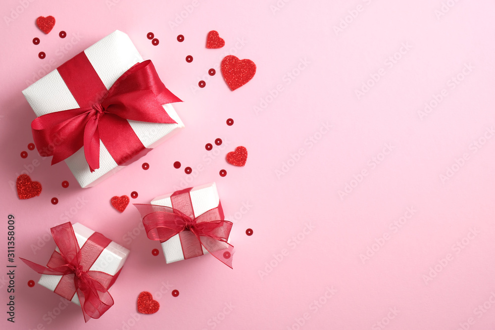 Gift boxes wrapped white paper with red ribbon bow and Valentines hearts on pink background. Flat lay, top view. Banner or greeting card mockup for Valentine's or Mother's Day.