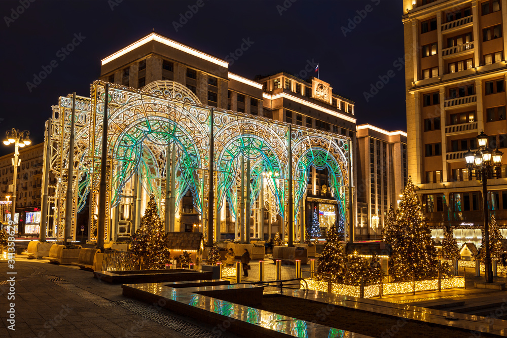 Glowing Christmas decorations on Manezh square in Moscow at Night, Moscow, Russia