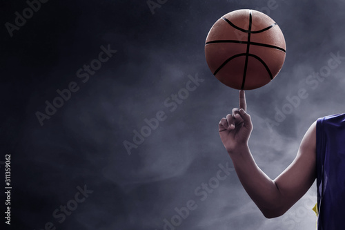 Basketball player spinning a ball © fotokitas
