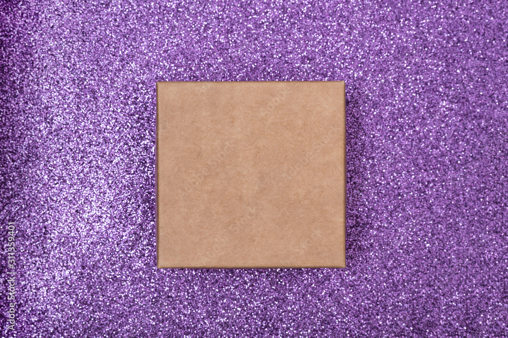 Fototapeta premium Square craft box on a shiny lilac surface. Directly above