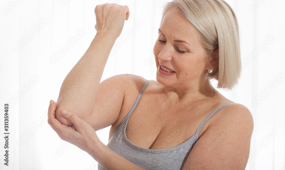 Woman with pain in arm, elbow. Pain in the human body, health care concept. Woman with pain in arm, elbow. Pain in the human body, health care concept.
