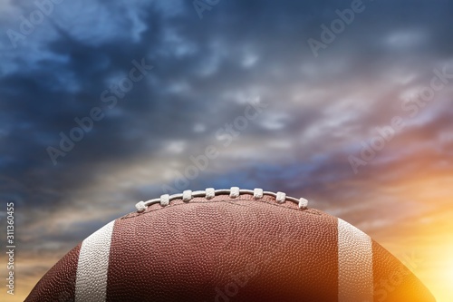 American football ball on sky background