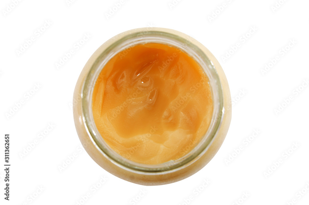 honey in a jar isolated on a white background. Top view. Close-up. honey in a jar isolated on a white background. Top view. Close-up.