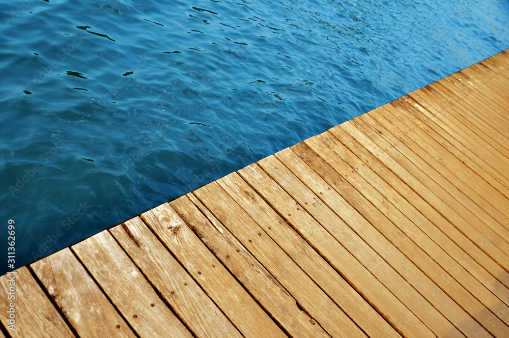 wooden pier with lake water
