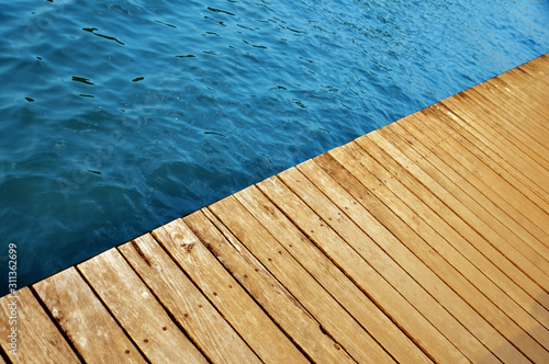 wooden pier with lake water © Dharshani