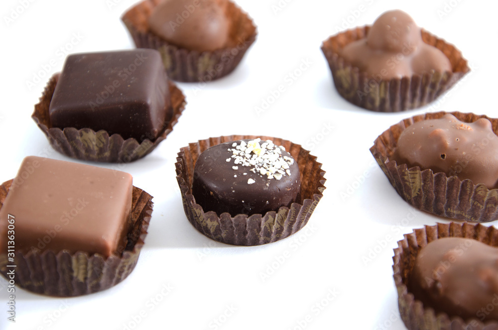chocolate candies in a candy wrapper on a white background. A set of sweets with different tastes .. chocolate candies in a candy wrapper on a white background. A set of sweets with different tastes ..
