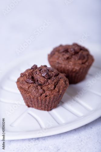 Wallpaper Mural Chocolate muffins on a white plate. Homemade baking. White background. Selective focus, close up. Torontodigital.ca