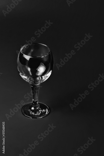 Empty wine glass on black background