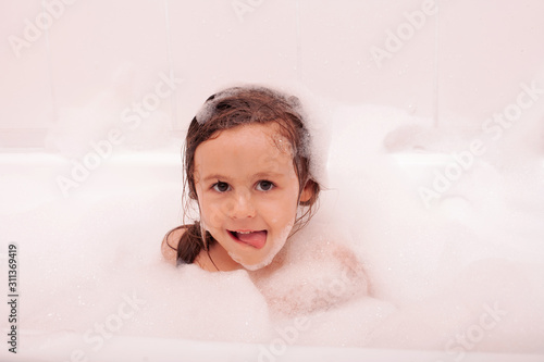happy funny kid laughing and bathed in the bath