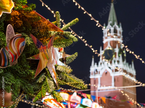 Decorative star on Christmas tree. New Year fair on Red square in Moscow. Spasskaya tower of Kremlin on background. Russia.
