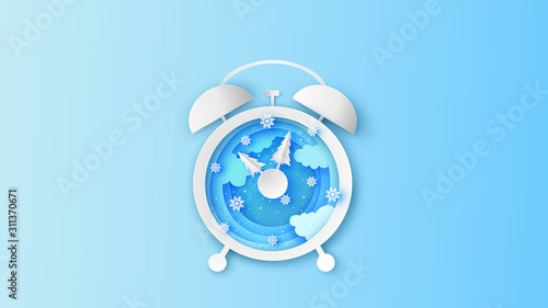 Creative design of winter landscape inside the alarm clock in the Mid morning. Alarm clock design for Winter. paper cut and craft style. vector, illustration.