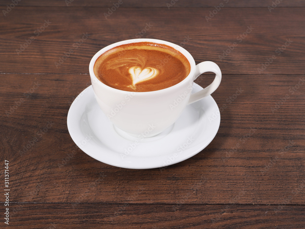 Cup of coffee on the wood table with latte art Cup of coffee on the wood table with latte art