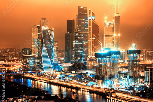 scenic moscow city russia architecture cityscape downtown landmark at night against dark orange sky background. Aerial top side view of russian capital skyline financial office district