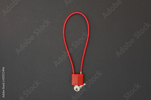 Firearm cable lock isolated on black background. 