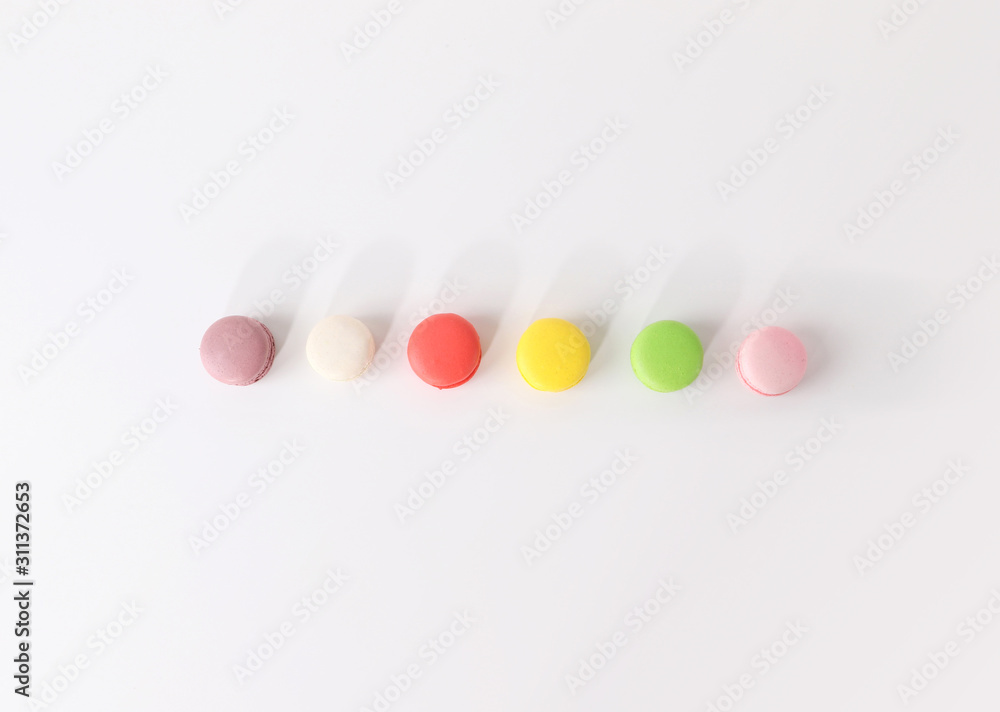 Obraz premium Colored macarons on white background