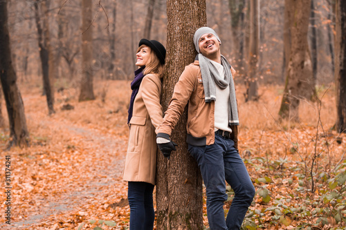 Couple in the park enjoying nice autumn   winter time.