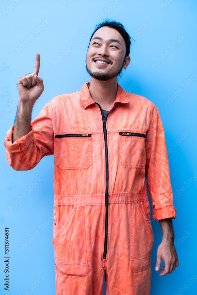 Fototapeta premium A mechanic is point above for presenting something