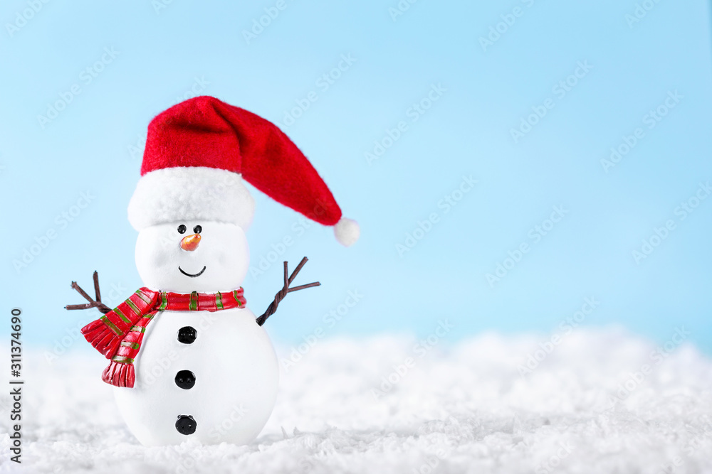 Snowman on snow over blue paper background. Winter holidays