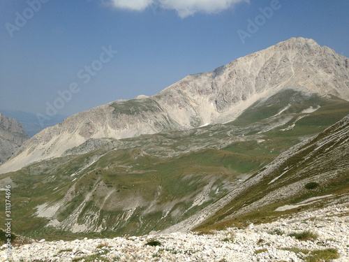 View of mountains and blue sky with clouds	