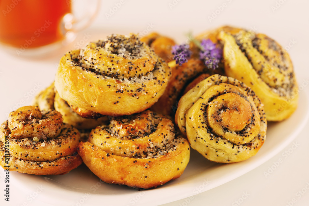 Homemade bun with poppy seeds and sugar, rolls on plate Homemade bun with poppy seeds and sugar, rolls on plate