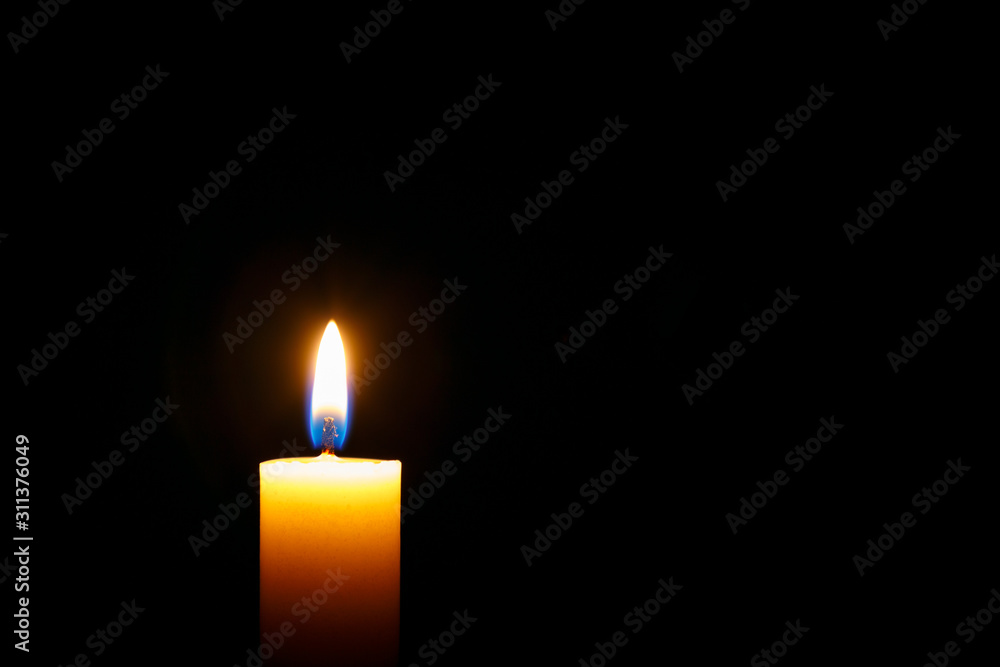 Burning candle on black background,space for text Burning candle on black background,space for text