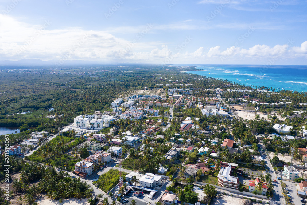 Caribbean city on tropical coastline. Aerial view from drone