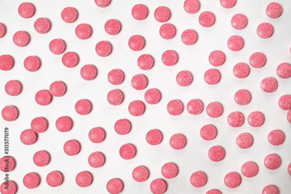 Red pills in white background, top view. Concept of prescription drugs or health improving supplements consumption Red pills in white background, top view. Concept of prescription drugs or health improving supplements consumption