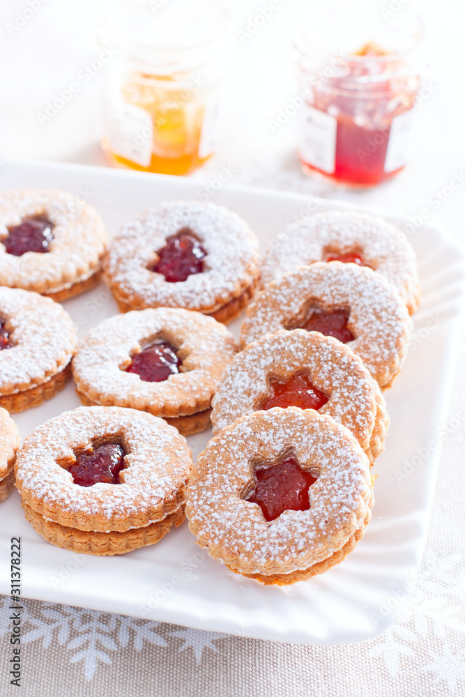 Traditional christmas linzer cookies on a white dish, selective focus