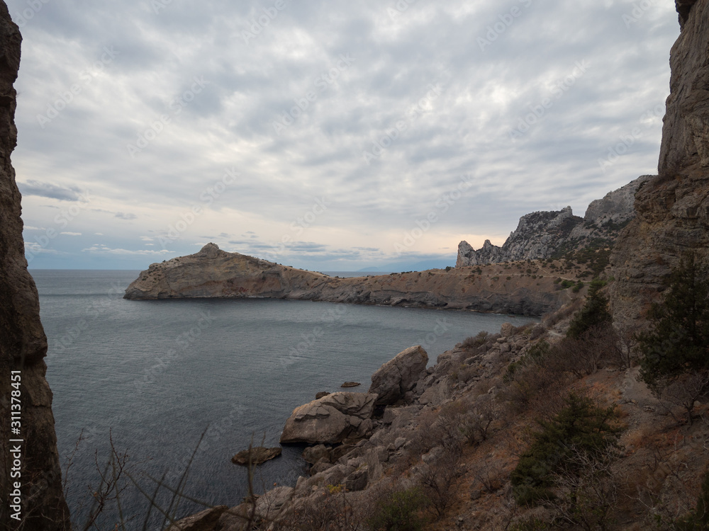 Dolphin-shaped mountain cape. Autumn view of the sea coast of Crimea. Autumn landscape, beautiful mountains, sea in a cloudy day