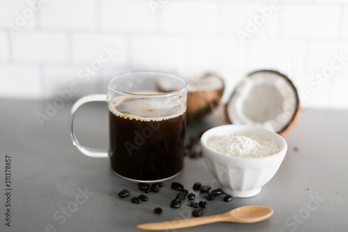 Slika na platnu Cup of coffee with keto coconut creamer in white modern kitchen