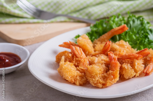 Fried shrimp and vegetable on plate.