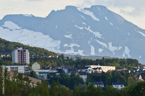 Houses and buildings on the hill with mountains background in Narvik, Norway