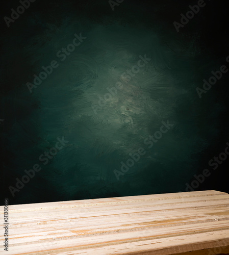 Wood table in front of rustic brick wall blur background with empty copy space on the table for product display mockup. Retro design montage presentation.