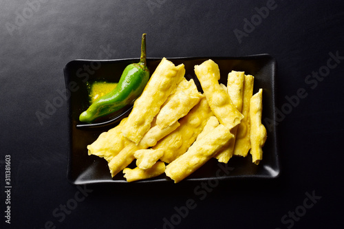 gujrati dish fafda with green chilli on dark background photo