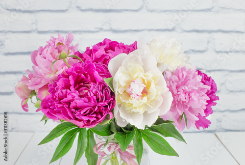 Beautiful bouquet of pink and white peonies. Holiday card with a bouquet of summer flowers. Summer flowers peonies.