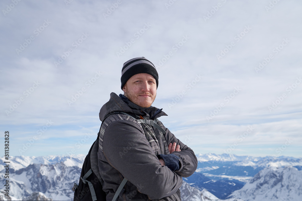 Traveler on the top of Zugspitze mountain, Germany. It is the highest peak of Wetterstein mountains in Germany.  It lies south of the town of Garmisch-Partenkirchen. Alps.