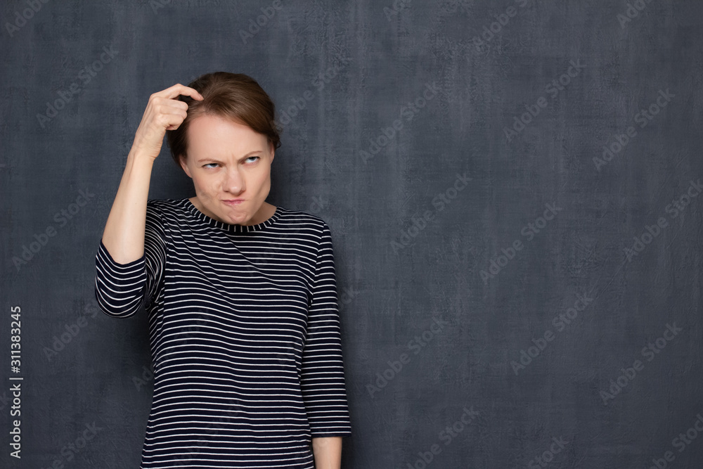 Portrait of funny focused puzzled woman scratching head with finger Portrait of funny focused puzzled woman scratching head with finger