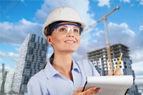 Portrait of Engineer in hard hemlet of on architecture background