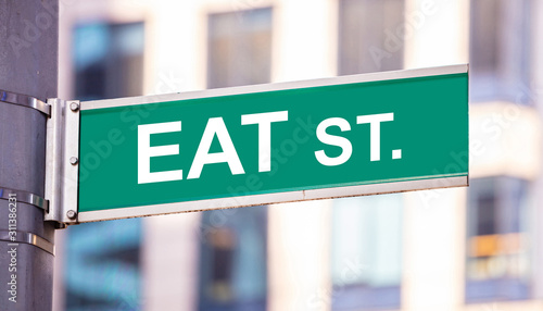 Eat street sign, street food concept, blur buildings background