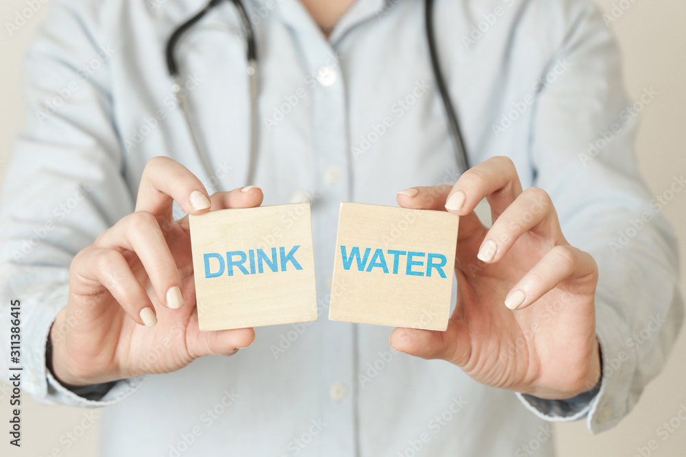 Doctor advises. Medical worker holds drink water sign, healthy lifestyle concept. Doctor advises. Medical worker holds drink water sign, healthy lifestyle concept.