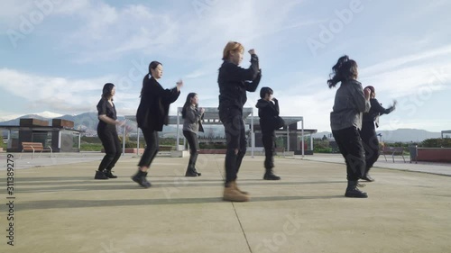 Young STREET PERFORMER performing on the street. Seven chinese teenagers dancing kpop