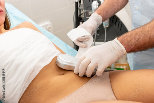 Woman stomach massage procedure Cosmetology slimming.