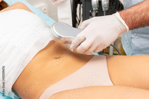 Woman stomach  massage procedure Cosmetology slimming.