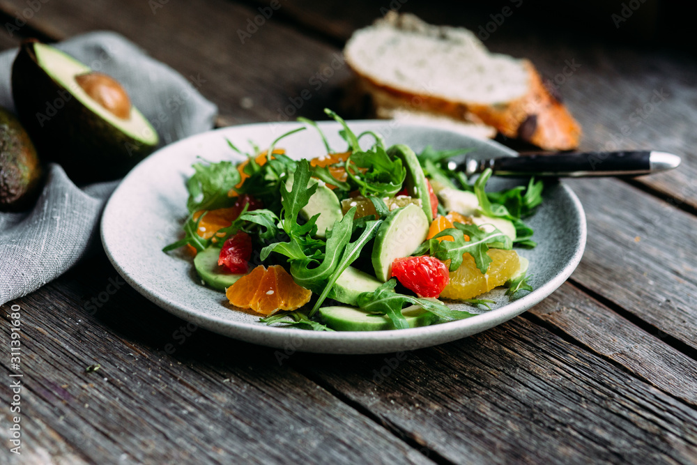 Vegetarian salad with arugula, oranges and grapefruit