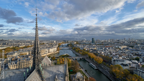 Panoramic view to the Paris and river Seine from the roof of Notre Dame cathedral, France. Cloudy weather. Autumn. 