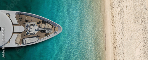 Aerial drone top view ultra wide photo of luxury yacht docked near exotic sandy turquoise beach © aerial-drone