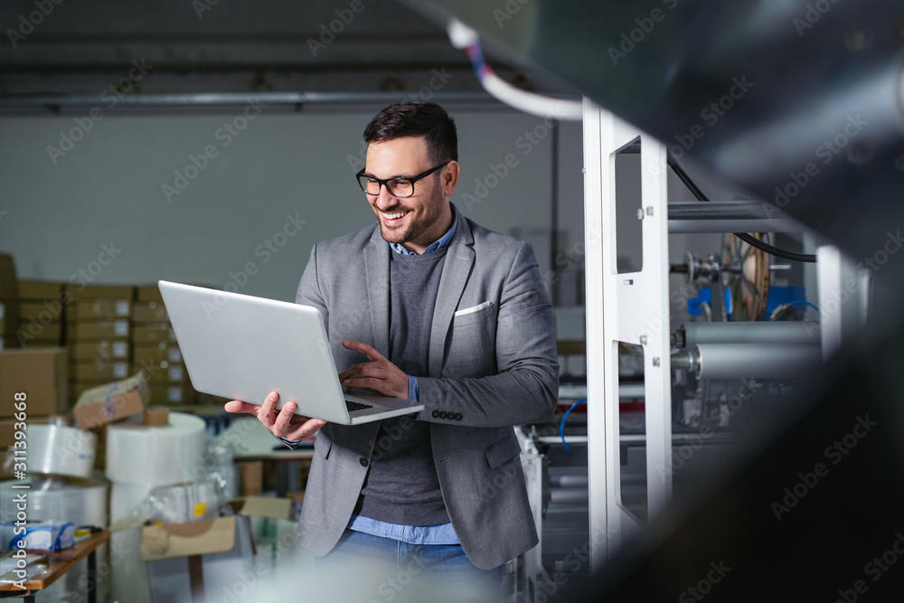 Fototapeta premium Engineer in the factory using laptop computer for maintenance.