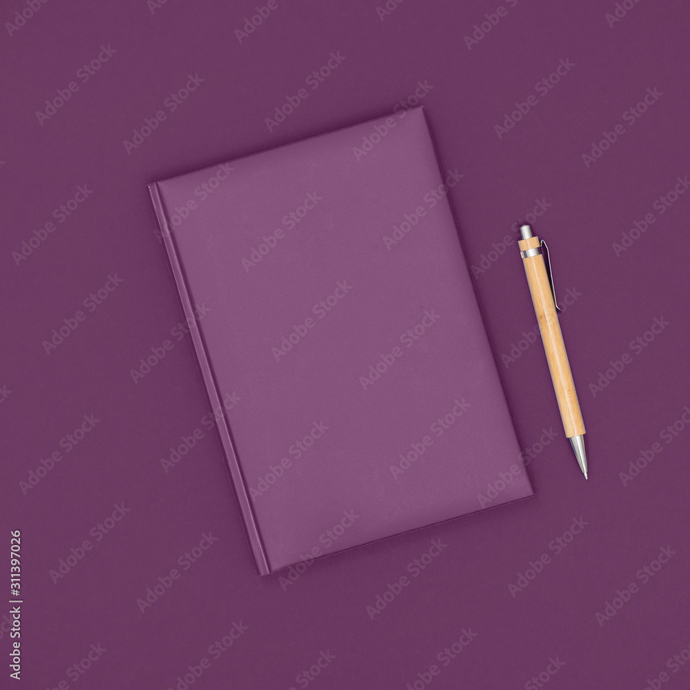 Notebook and pen on purple background. Business concept. Top view, flat lay, copy space. Notebook and pen on purple background. Business concept. Top view, flat lay, copy space.