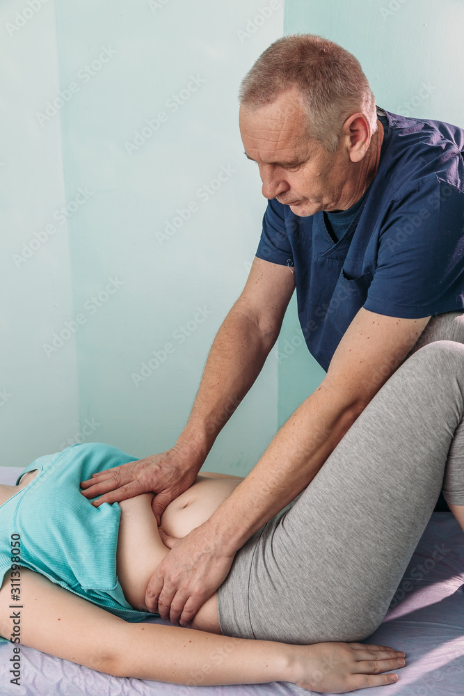 therapist applying pressure on stomach detail of hands massaging female belly therapist applying pressure on stomach detail of hands massaging female belly